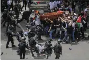  ?? MAYA LEVIN — THE ASSOCIATED PRESS ?? Israeli police confront mourners as they carry the casket of slain Al Jazeera veteran journalist Shireen Abu Akleh during her funeral in east Jerusalem on Friday.
