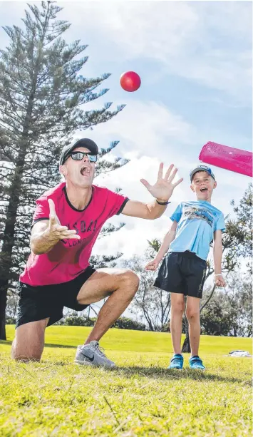  ??  ?? Dad Marcus Kain with six-year-old twins Lucas and Noah and Theodore Moore, 6, enjoying agame of cricket at Broadbeach on the Easter Monday public holiday.