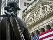  ?? THE ASSOCIATED PRESS ?? Federal Hall’s George Washington statue stands near the flagcovere­d pillars of the New York Stock Exchange.