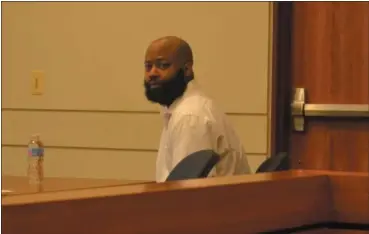  ?? KEITH REYNOLDS — THE MORNING JOURNAL ?? Abline Cannon, 38, of Cleveland, sits alone Aug. 21 awaiting the first witness in his murder trial in Lorain County Common Pleas Court.