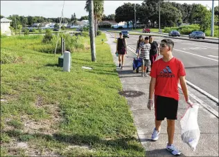  ?? JUAN CARLOS CHAVEZ/TAMPA BAY TIMES/TNS ?? Connor Tooley, 17, has autism and his mother, Maria “Lalita” Tooley, says walking outdoors has improved her son’s personalit­y and attitude.