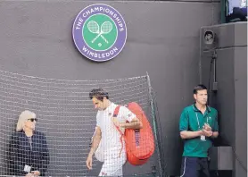  ?? BEN CURTIS/ASSOCIATED PRESS ?? Roger Federer leaves the court after losing in the men’s quarterfin­als at Wimbledon Wednesday. Federer, the tournament’s top seed, blew a two-set lead and eventually fell to eighth-seeded Kevin Anderson.