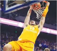  ?? AP PHOTO/JAMES CRISP ?? Tennessee’s Olivier Nkamhoua dunks during the Vols’ 66-54 loss at Kentucky on Saturday.