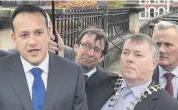  ??  ?? Taoiseach Leo Varadkar speaks to media in Londonderr­y on Saturday next to the mayor of Donegal, Gerry McMonagle (second right)