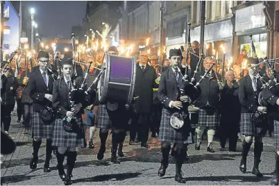  ?? Picture: Sandy McCook. ?? Torchlight procession along Fort William High Street to the Nevis Centre as last October’s Royal National Mòd opened in the town.