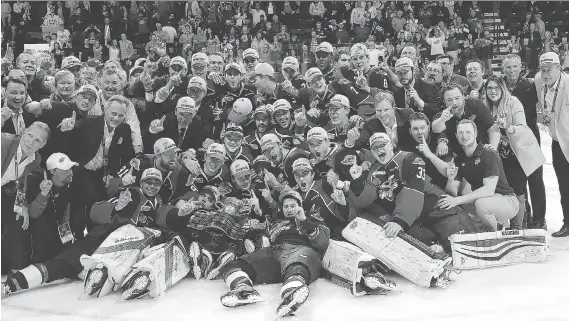  ?? DAN JANISSE ?? The Windsor Spitfires pose for a team photo after winning the Memorial Cup trophy on May 28.