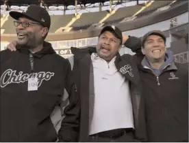  ?? The Associated Press ?? Chicago White Sox groundskee­per Nevest Coleman, center, laughs with friend and fellow grounds crew Harry Smith Jr., left, and friend and now supervisor Jerry Powe, at Guaranteed Rate Field in Chicago, Monday.