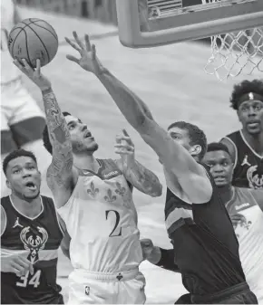  ?? ASSOCIATED PRESS ?? Pelicans guard Lonzo Ball shoots over Bucks center Brook Lopez in the first half Friday in New Orleans.