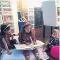  ??  ?? THEN: Hana, Lyla and Ruby read and play in their home’s old dining area, whose walls are lined with storage containers.