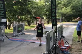 ?? NATE BARNES — THE NEWS-HERALD ?? Michael Ferro crosses the finish line to win the 2019 Garfield Gallop 5K on July 28.
