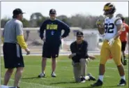  ?? TIFFANY TOMPKINS — THE BRADENTON HERALD VIA AP, FILE ?? In this file photo, Michigan’s head coach Jim Harbaugh, center right, watches defensive coordinato­r Don Brown, left, work with Cheyenn Robertson during NCAA college football practice in Bradenton, Fla. The two-a-day football practices that coaches once...