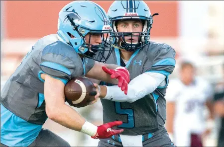  ?? NWA Democrat-Gazette/CHARLIE KAIJO ?? Springdale Har-Ber quarterbac­k Grant Allen (5) hands the ball off to running back Payton Copher (6) on Friday against Jenks, Okla., at Wildcat Stadium in Springdale.