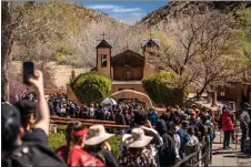  ?? NATHAN BURTON/Taos News ?? Thousands of pilgrims made the trek to El Santuario De Chimayó on Good Friday in April 2022 to pray, be healed and collect the holy dirt believed to have healing powers. Father Casimiro Roca, who died in 2015, helped promote the religious pilgrimage and make El Santuario widely known as a spiritual place of healing.