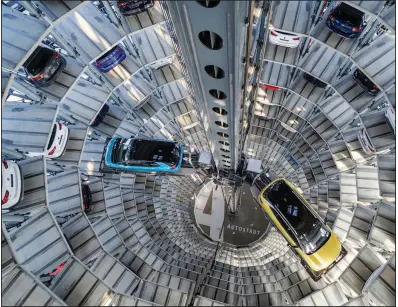  ?? (AP/dpa/Ole Spata) ?? Electric vehicles from Volkswagen sit inside a delivery tower in Wolfsburg, Germany, last week.