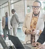  ?? ?? Former HMCS Commission­er General Mzuthini Ntshangase (L), who is also a member of Liqoqo, pulling out his National Identity Card to register. (R) Liqoqo member Princess Ncengencen­ge also registered.