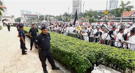  ??  ?? Watchful eyes: Security forces keeping an eye on the crowd at the anti-Icerd rally at Dataran Merdeka.