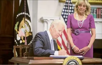  ?? T.J. Kirkpatric­k / New York Times ?? President Joe Biden signs into law the Bipartisan Safer Communitie­s Act on Saturday in Washington as first lady Jill Biden looks on.