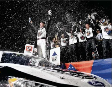  ?? JARED C. TILTON / GETTY IMAGES ?? Kevin Harvick celebrates in Victory Lane after winning the rain-delayed QuikTrip 500 at Atlanta Motor Speedway in Hampton, Georgia, on Sunday.