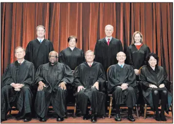  ?? Erin Schaff The Associated Press ?? Members of the Supreme Court pose for a group photo in April. Seated from left are Associate Justice Samuel Alito, Associate Justice Clarence Thomas, Chief Justice John Roberts, Associate Justice Stephen Breyer and Associate Justice Sonia Sotomayor. Standing from left are Associate Justice Brett Kavanaugh, Associate Justice Elena Kagan, Associate Justice Neil Gorsuch and Associate Justice Amy Coney Barrett.