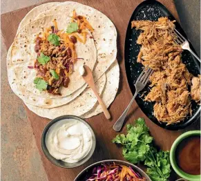  ??  ?? Pull your slow cooker out and make... pulled pork taco with winter slaw.