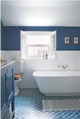  ??  ?? BATHROOM The smart white and blue palette adds to the crisp, coastal style.
Clearwater Palermo Grande freestandi­ng composite stone bath, £1,399, Designer Bathroom Concepts. Fez encaustic cement tiles, £74sq m, Encaustic Tiles