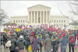  ?? PABLO MARTINEZ MONSIVAIS/ASSOCIATED PRESS ?? A crowd gathers March 4 outside the Supreme Court in Washington, as the court hears arguments in King v. Burwell. A new poll finds that most Americans are totally unaware that the Supreme Court case could unravel President Barack Obama’s health care law.