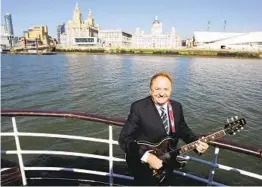  ?? DAVE THOMPSON AP FILE ?? Gerry and the Pacemakers singer Gerry Marsden rides the ferry across the River Mersey in Liverpool, England, in homage to one of his group’s hits.