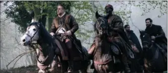  ?? PHOTO COURTESY OF DANIEL SMITH - WARNER BROS. ?? Shown from left are, Charlie Hunnam as Arthur, Djimon Hounsou as Bedivere, Kingsley Ben-Adir as Wet Stick and Craig Mcginlay as Percival in “King Arthur: Legend Of The Sword.”