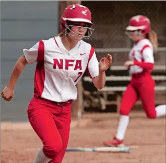  ?? DANA JENSEN/THE DAY ?? Norwich Free Academy’s Beth Fleming (7) runs towards first base as teammate Jordan Nute, background, reaches home plate to score on Fleming’s RBI single during the Wildcats’ 15-0, six-inning victory over Tourtellot­te in the quarterfin­als of the Eastern...