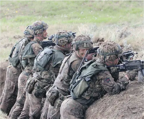  ?? PHOTOS: TRISTIN HOPPER / NATIONAL POST ?? British soldiers man a trench during Prairie Fire war games at CFB Suffield near Medicine Hat in Alberta.