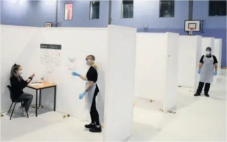  ??  ?? The University of Bath has identified sites in the city and on campus that could become coronaviru­s testing centres, such as this one that opened at Glasgow Caledonian University last week. Inset below, Dr Bruce Laurence