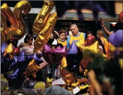  ?? CHRISTINA HOUSE/LOS ANGELES TIMES ?? Fans gather at a memorial for Kobe Bryant at L.A. Live on Sunday. A public memorial for Bryant is set for Feb. 24 at the Staples Center.