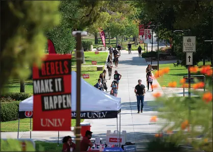  ?? STEVE MARCUS ?? Students walk along a path Aug. 24 on the campus of UNLV.