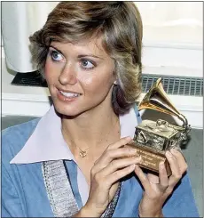  ??  ?? WINNER: Olivia in 1975 with one of her Grammys