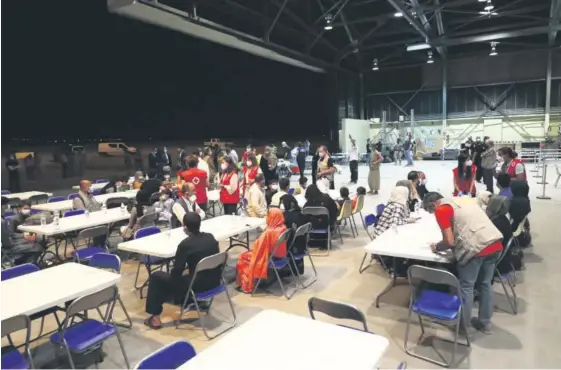  ?? Foto: E.P. ?? Un grupo de refugiados afganos son atendidos en la base aérea de Torrejón de Ardoz, en Madrid.