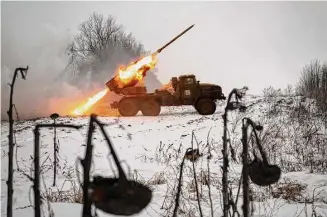  ?? Vadim Ghirda/Associated Press ?? Ukrainian military fires from a multiple rocket launcher at Russian positions in the Kharkiv area of Ukraine on Saturday. The Biden administra­tion declared its Ukraine solidarity with fresh action as well as strong words on Friday, piling sweeping new sanctions on Moscow and approving a new $2 billion weapons package to re-arm Kyiv a year after Russia’s invasion.