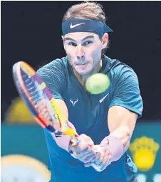  ?? — AFP photo ?? Nadal returns against Rublev in their men’s singles round-robin match on day one of the ATP World Tour Finals tennis tournament at the O2 Arena in London.