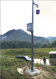  ??  ?? Staff members check a surveillan­ce camera at the entrance of Yele Nature Reserve in Sichuan.