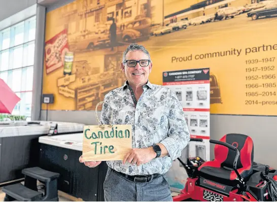  ?? THINH NGUYEN • THE GUARDIAN ?? Cameron Beach, owner-operator of Charlottet­own’s Canadian Tire, holds up the small wooden sign he found outside the store on the morning of April 12. He later connected with the sign’s maker, leading to a $5,000 donation to the provincial Cancer Treatment Centre on behalf of this person.