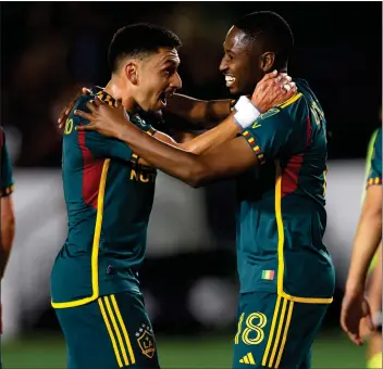  ?? PHOTO BY RAUL ROMERO JR. ?? Galaxy defender Kelvin Leerdam, right, celebrates with midfielder Marco Delgado after Leerdam scored during the first half against the Vancouver Whitecaps on Saturday night at Dignity Health Sports Park.