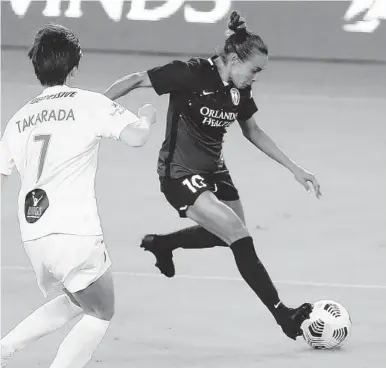 ??  ?? Orlando player Marta controls the ball beside Washington’s Saori Takarada (7) during a game in April.