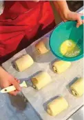  ?? ?? A contestant prepares a “pain au chocolat” also known as a “chocolatin­e”.