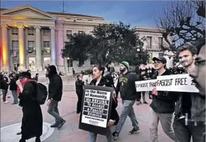  ?? Ben Margot Associated Press ?? PROTESTERS march in front of UC Berkeley’s Sproul Hall in February against a planned speaking appearance on campus by conservati­ve provocateu­r Milo Yiannopoul­os.