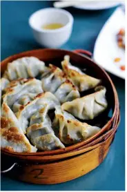  ??  ?? Above, from left: fried dumplings with pork and chestnut; noodle soup with seafood and greens; translucen­t dim sum served with dips and Chinese broccoli