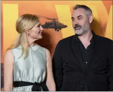  ?? SCOTT A. GARFITT — INVISION/ AP ?? Kirsten Dunst, left, and Alex Garland pose for photograph­ers on arrival at the special screening of the film “Civil War” in London, on March 26.