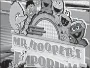  ?? HARRY SIRCELY/BUCKS COUNTY COURIER TIMES ?? Mr. Hooper’s Emporium sign gets a new coat of paint in 2005 at the Sesame Place theme park near Philadelph­ia.