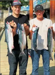  ?? TOM TATUM - FOR DFM ?? Frenchmen Sacha Sarfati (left) and his father Michel Sarfati display sockeye salmon caught in British Columbia’s Salish Sea.