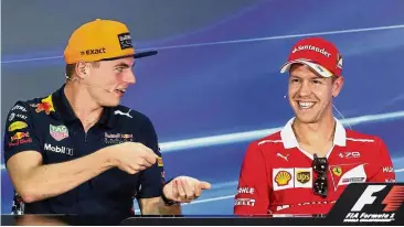  ??  ?? Calm before the storm: Red Bull’s Max Verstappen (left) having a word with Ferrari’s Sebastian Vettel during a press conference at the Sepang Internatio­nal Circuit yesterday.