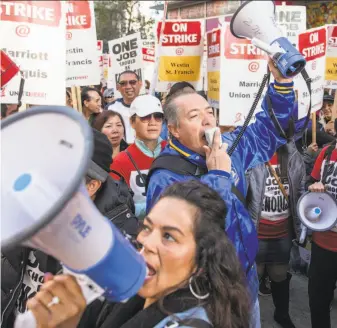  ?? Jessica Christian / The Chronicle ?? Hospitalit­y workers gather on Market Street last month to protest the hotel chain. With no deal in sight, the strike will continue through Thanksgivi­ng week, a union representa­tive says.