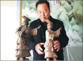  ?? HUO YAN / CHINA DAILY ?? Cao Shuquan with two Yellow Emperor figures he made from clay.